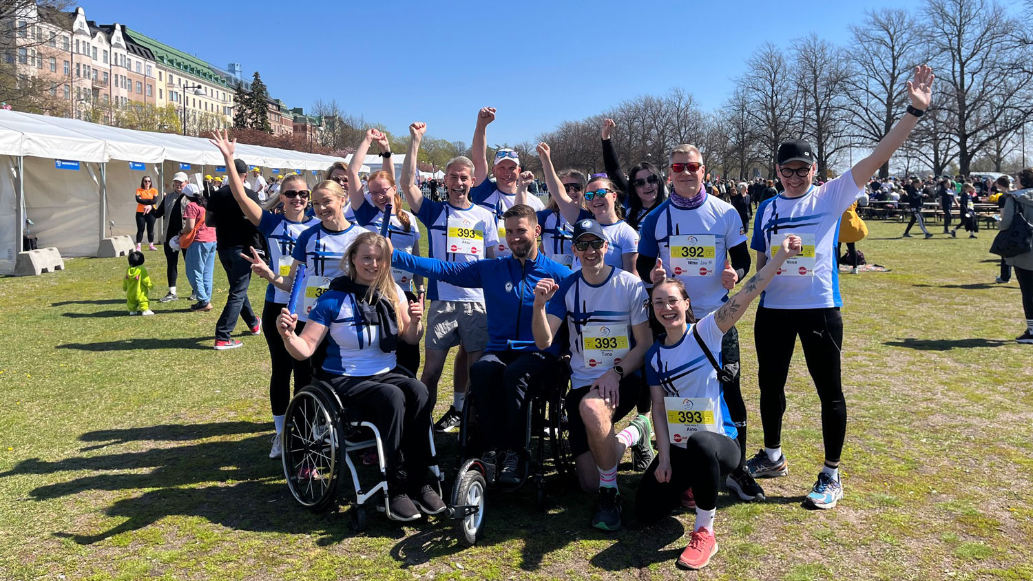 Paralympiakomitean joukkue iloisessa yhteiskuvassa Helsingin Meri-ja Kaivopuistossa.